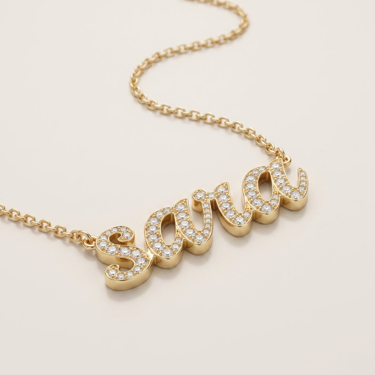 modern script pendant of the name sara in yellow gold and diamonds