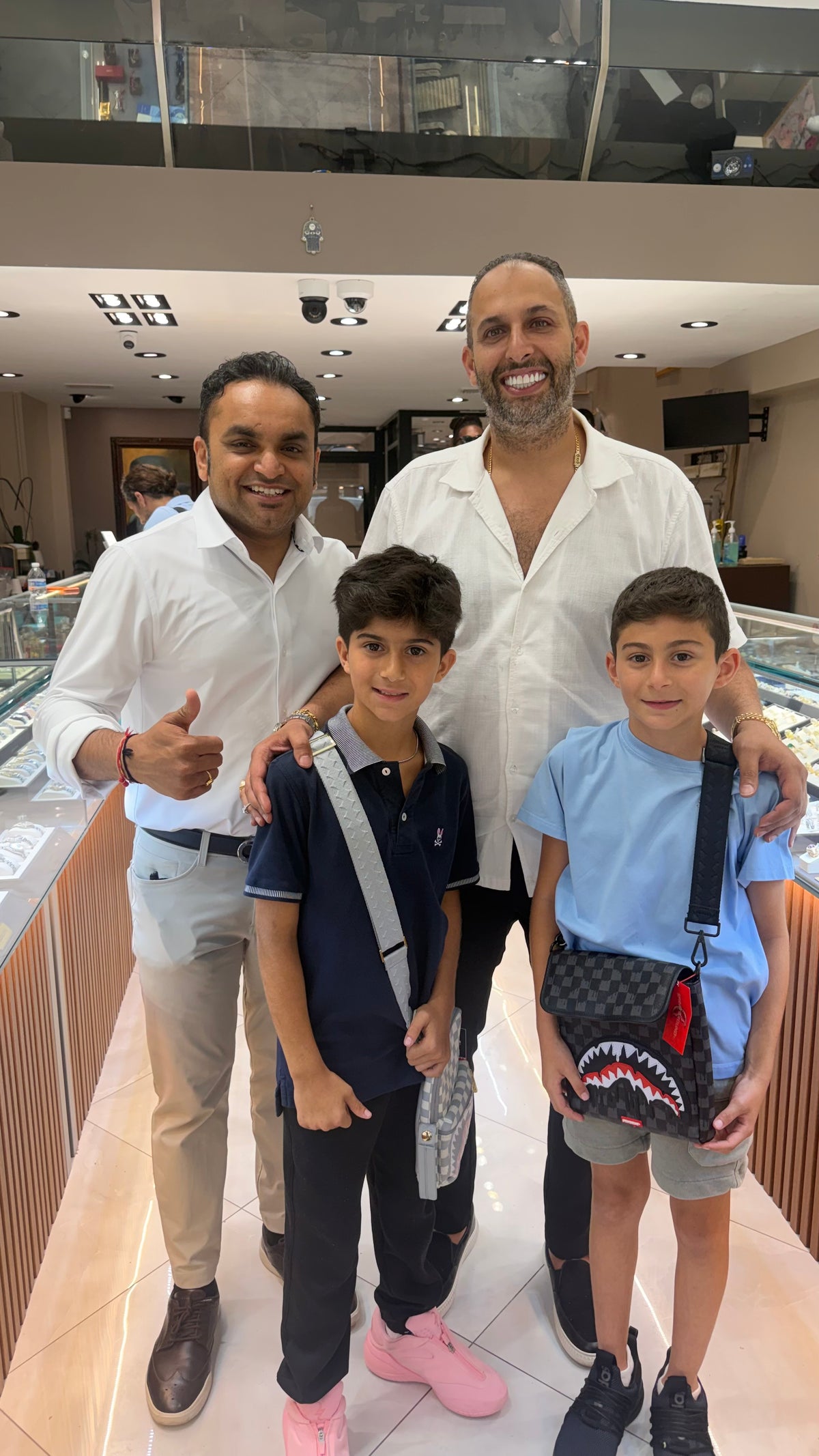 Benny with a man and two boys at the Mazalito counter, 76 W 47th Street