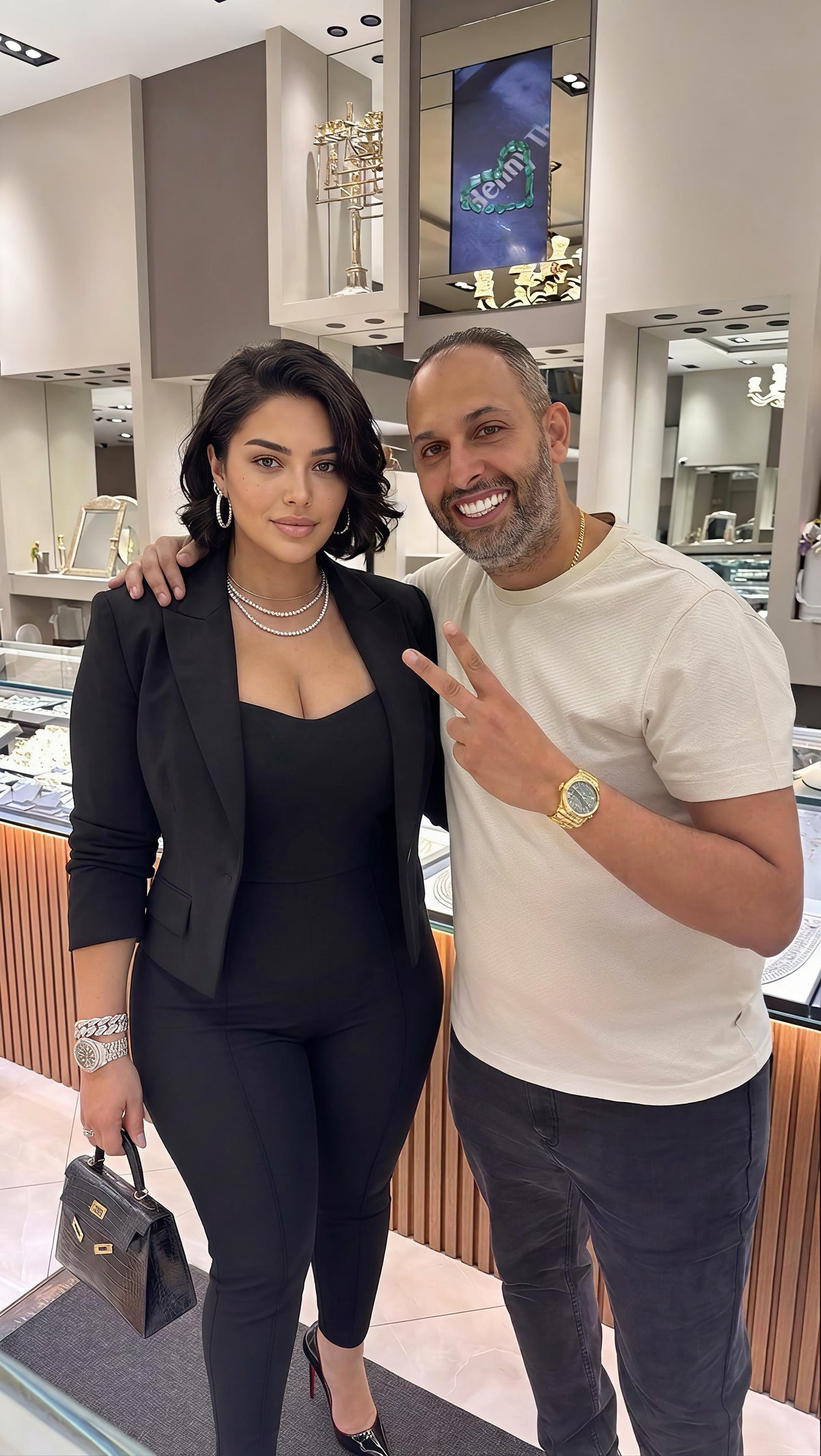 Benny with a customer wearing layered necklaces and hoops at the Mazalito counter, 76 W 47th Street